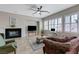 Bright living room features a fireplace, ceiling fan, and a large window with shutters at , Las Vegas, NV 89149