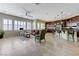 Open-concept living room with tile floors, plantation shutters, and a kitchen bar, perfect for entertaining at , Las Vegas, NV 89149