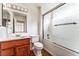 Bathroom features a shower-tub combo with glass doors, plus a wood vanity with sink at 10029 Netherton Dr, Las Vegas, NV 89134