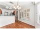 Well-lit dining room connected to kitchen boasts a chandelier and bright window features at 10029 Netherton Dr, Las Vegas, NV 89134