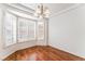 Bright dining room with wood floors, large windows with white shutters, and elegant chandelier at 10029 Netherton Dr, Las Vegas, NV 89134