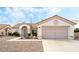 Charming single-story home with a two-car garage, desert landscaping, and a tile roof at 10029 Netherton Dr, Las Vegas, NV 89134