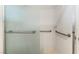 Shower with sliding glass door, white tile and grab bars at 10029 Netherton Dr, Las Vegas, NV 89134
