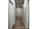 Long hallway showcasing laminate wood flooring and neutral walls at 1060 Hall Ave, Pahrump, NV 89048