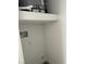 Compact utility space with hookups, shelf, and water heater at 1060 Hall Ave, Pahrump, NV 89048