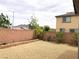 Landscaped backyard featuring a brick wall and decorative stone at 1064 Blue Wine Ct, Henderson, NV 89002