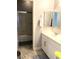 Bright bathroom with tiled floors, white vanity with sink, and a shower with a glass door at 1064 Blue Wine Ct, Henderson, NV 89002
