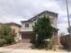 Charming two-story home showcasing a stone facade and a well-manicured lawn at 1064 Blue Wine Ct, Henderson, NV 89002
