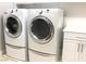 Modern laundry room featuring front load washer and dryer and storage cabinets at 1064 Blue Wine Ct, Henderson, NV 89002