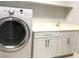 Laundry room with modern washer, utility sink, and plenty of storage space at 1064 Blue Wine Ct, Henderson, NV 89002