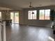 Bright living room with tile flooring, large windows, and access to the dining area and backyard at 1064 Blue Wine Ct, Henderson, NV 89002
