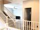 View from the landing showing the spacious living room, ceiling fan, and wood-look flooring at 1064 Blue Wine Ct, Henderson, NV 89002