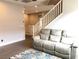 Inviting living room with a cozy couch and staircase at 1064 Blue Wine Ct, Henderson, NV 89002