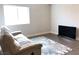 Comfortable living room with a large window, plush couch, and modern television at 1064 Blue Wine Ct, Henderson, NV 89002