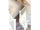 Modern staircase with carpeted steps and white railing, adding elegance to the home's interior at 1064 Blue Wine Ct, Henderson, NV 89002