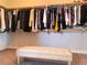 Well-organized walk-in closet with ample hanging space and a stylish center bench at 1064 Blue Wine Ct, Henderson, NV 89002