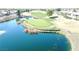 Aerial view of a golf course with water feature on a sunny day at 10717 Grand Cypress Ave, Las Vegas, NV 89134