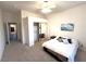 Bright bedroom featuring a ceiling fan, mirrored closet doors, and neutral carpeting at 10717 Grand Cypress Ave, Las Vegas, NV 89134