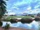 Scenic golf course view with water features and mountain backdrop at 10717 Grand Cypress Ave, Las Vegas, NV 89134