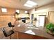 A kitchen featuring neutral cabinets, granite countertops, tile floors, and a skylight for ample natural lighting at 10717 Grand Cypress Ave, Las Vegas, NV 89134