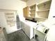Laundry room featuring a sink, washer, dryer, and storage shelves at 10717 Grand Cypress Ave, Las Vegas, NV 89134