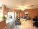 A spacious living room with tile floors, a ceiling fan, and neutral paint, and a comfortable seating arrangement at 10717 Grand Cypress Ave, Las Vegas, NV 89134