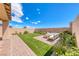 Spacious backyard featuring artificial turf, a brick-paved patio, and privacy landscaping at 10979 Bristol Park Ave, Las Vegas, NV 89166