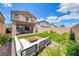 The backyard presents a well-kept lawn with patio space, perfect for outdoor gatherings and leisure at 10979 Bristol Park Ave, Las Vegas, NV 89166