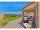 The backyard offers a well-manicured lawn, inviting patio area and views of the surrounding landscape at 10979 Bristol Park Ave, Las Vegas, NV 89166