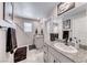 Modern bathroom with double sinks, granite countertops, and updated fixtures at 10979 Bristol Park Ave, Las Vegas, NV 89166