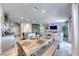Bright dining area with a large wooden table, bench seating, and stylish decor at 10979 Bristol Park Ave, Las Vegas, NV 89166