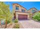 Inviting two-story home featuring manicured landscaping and a brick driveway, offering curb appeal at 10979 Bristol Park Ave, Las Vegas, NV 89166