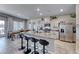 A spacious kitchen features stainless steel appliances, a large island with seating, and granite countertops at 10979 Bristol Park Ave, Las Vegas, NV 89166