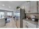 Modern kitchen with stainless steel appliances, granite countertops, and an adjacent dining area at 10979 Bristol Park Ave, Las Vegas, NV 89166