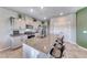 Kitchen with granite counters, stainless appliances, an island with seating, and modern gray cabinets at 10979 Bristol Park Ave, Las Vegas, NV 89166