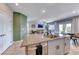 Kitchen with granite countertops and island with sink overlooks a living room, with open floor plan at 10979 Bristol Park Ave, Las Vegas, NV 89166