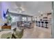 Open-concept living room and kitchen featuring a large sofa and modern decor at 10979 Bristol Park Ave, Las Vegas, NV 89166