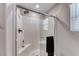 Clean shower features glass door, white tile, and built-in seat at 10979 Bristol Park Ave, Las Vegas, NV 89166