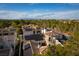 A high-angle view of terra-cotta roofs, showing solar panels and neighborhood greenery, with the city skyline in the distance at 11830 Kingsbarns Ct, Las Vegas, NV 89141