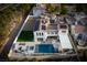 Drone shot showcasing a backyard with a pool, spa, patio, and green lawn at 11830 Kingsbarns Ct, Las Vegas, NV 89141