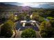 Attractive gated community entrance with lush landscaping, adjacent to a golf course and green spaces, with mountains in the background at 11830 Kingsbarns Ct, Las Vegas, NV 89141