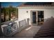 Balcony with a seating area, a stone railing, and sliding door access to the interior at 11830 Kingsbarns Ct, Las Vegas, NV 89141
