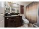 Bathroom featuring a dark wood vanity, granite countertops, and a shower with a curtain at 11830 Kingsbarns Ct, Las Vegas, NV 89141