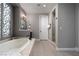 Serene bathroom boasts a soaking tub, separate glass-enclosed shower, and elegant fixtures for ultimate relaxation at 11830 Kingsbarns Ct, Las Vegas, NV 89141