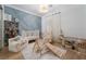 Charming Bedroom with white crib, bookshelf, play area, blue accent wall, and ample natural light at 11830 Kingsbarns Ct, Las Vegas, NV 89141