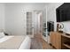 Bright bedroom with hardwood floors, french doors, and a neutral color palette at 11830 Kingsbarns Ct, Las Vegas, NV 89141