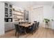 Chic dining room with custom shelving, statement chandelier, and ample natural light at 11830 Kingsbarns Ct, Las Vegas, NV 89141