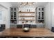 Elegant dining area with custom shelving and striking light fixture at 11830 Kingsbarns Ct, Las Vegas, NV 89141