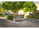 Landscaped community entrance with stone sign reading 'Kingsbarns Court' and lush greenery at 11830 Kingsbarns Ct, Las Vegas, NV 89141