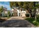 Elegant single-story home featuring a brick driveway and a symmetrical facade with two garage doors at 11830 Kingsbarns Ct, Las Vegas, NV 89141